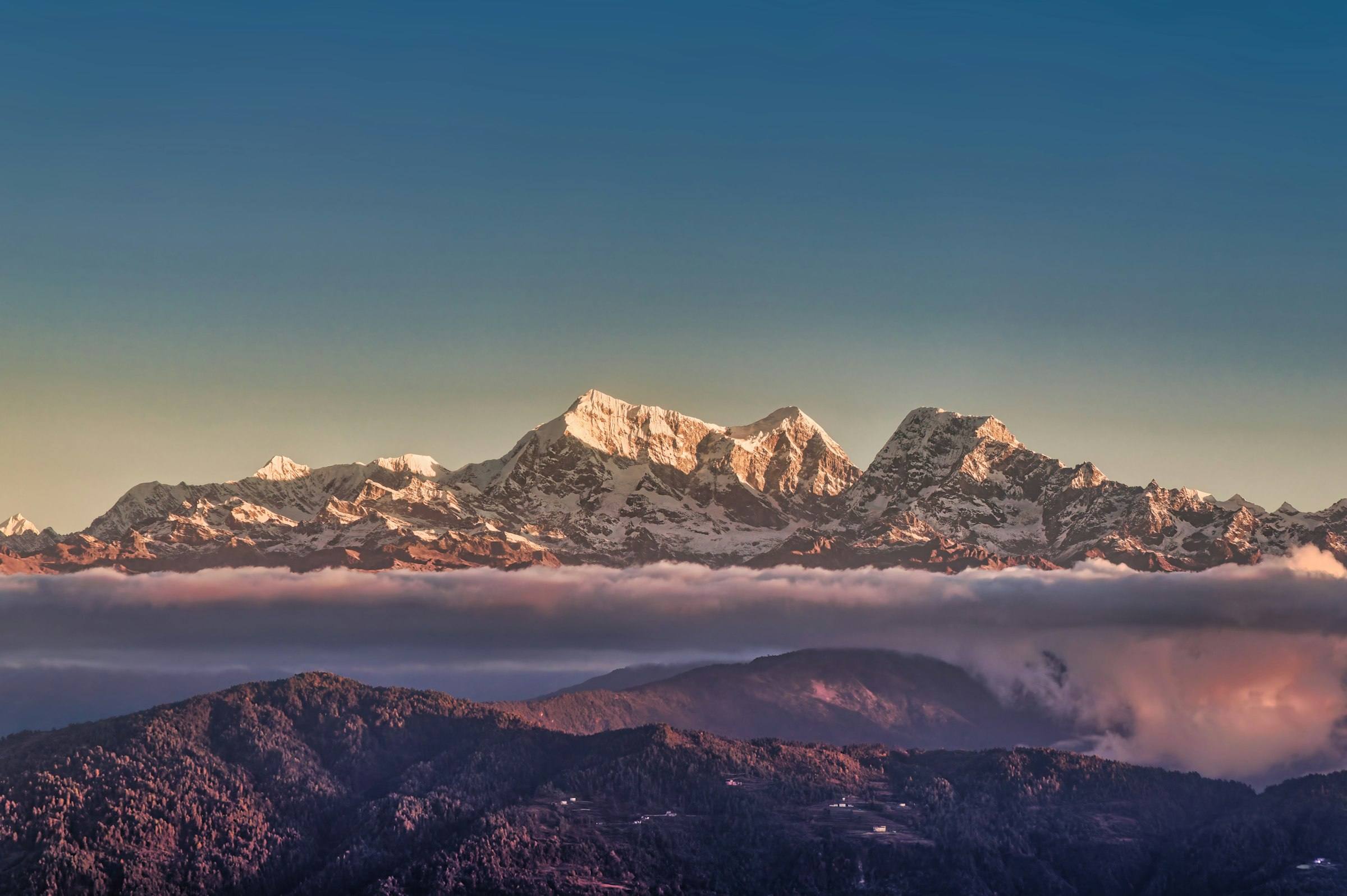 Snow-capped Himalaya rising above the clouds at sunrise