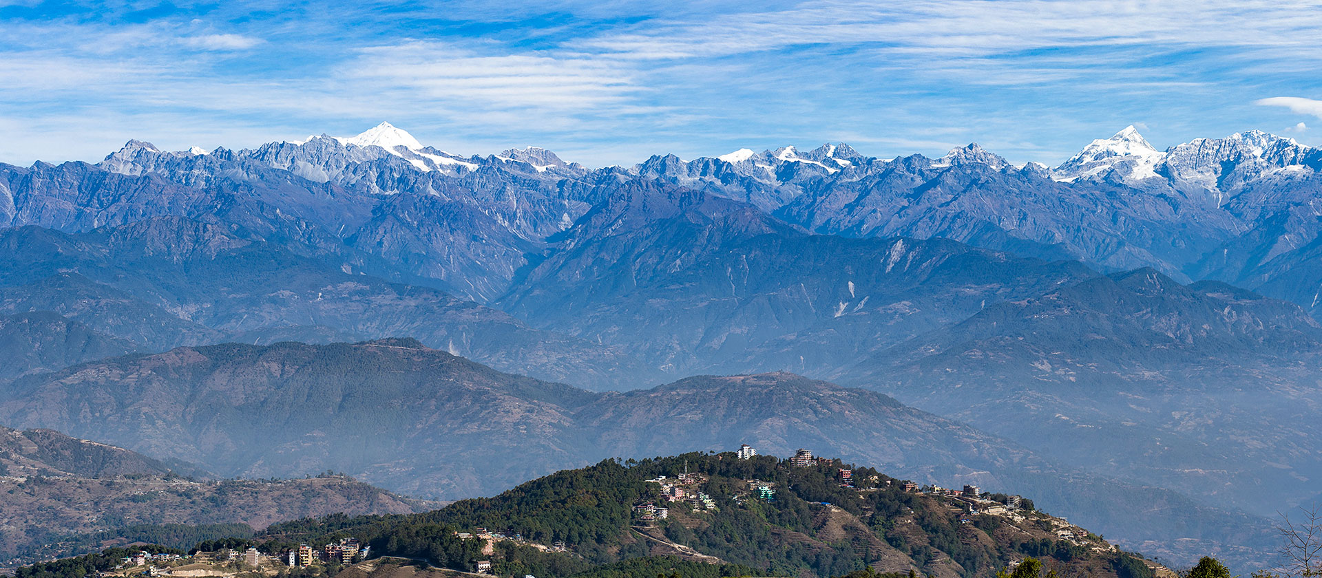 Snow-capped Himalayan range above green hills near Nagarkot
