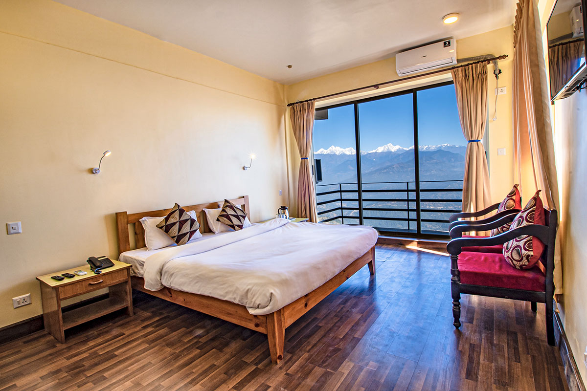 Deluxe king room with wooden furnishings and a mountain-view balcony