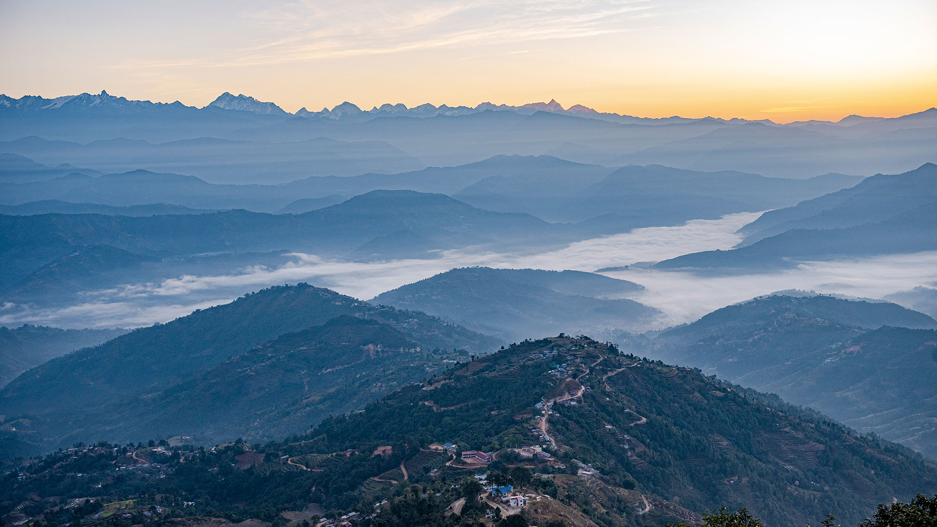 Misty hills below the Himalaya at dawn, seen from Hotel Green Valley