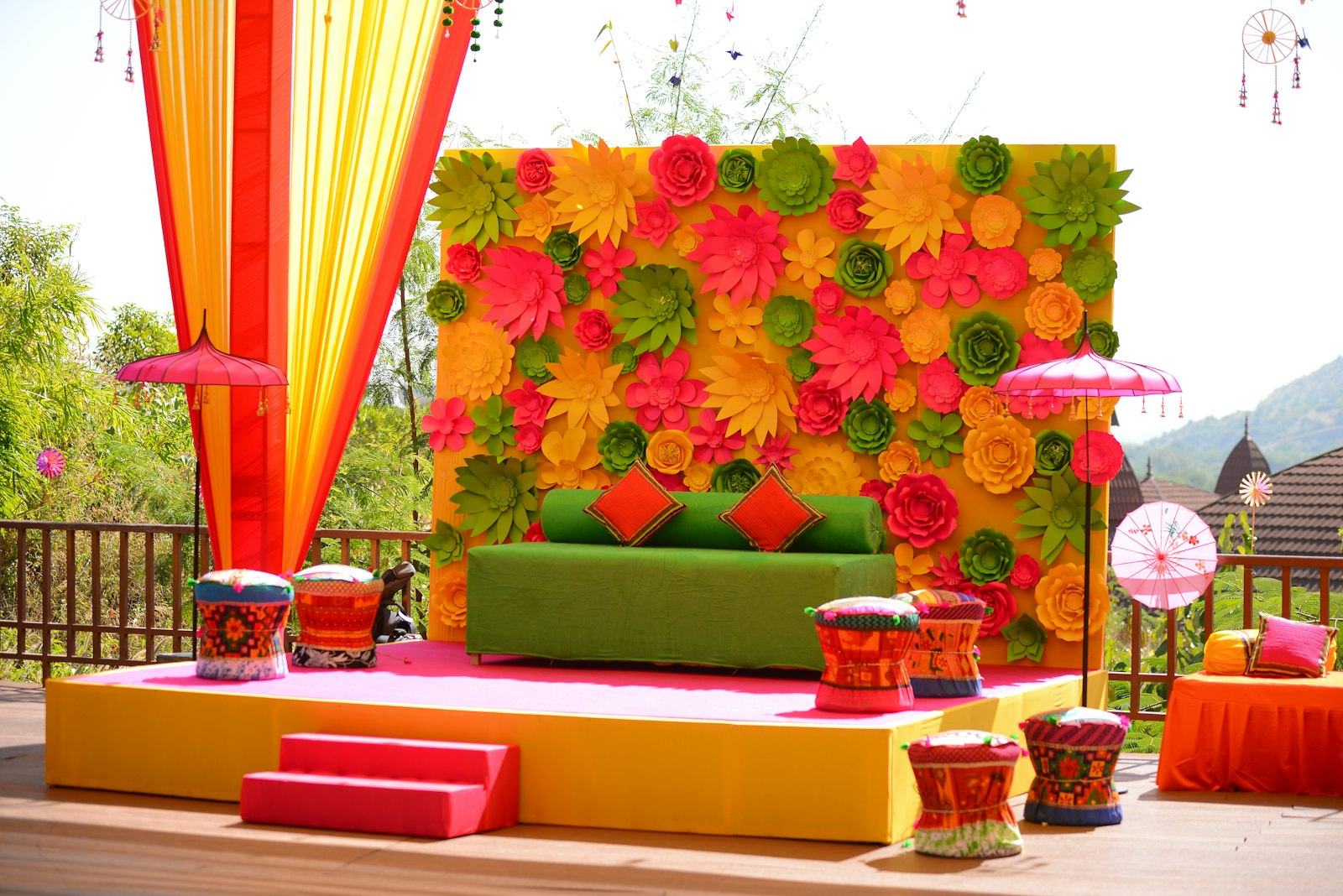 Colourful outdoor wedding stage with green hills behind